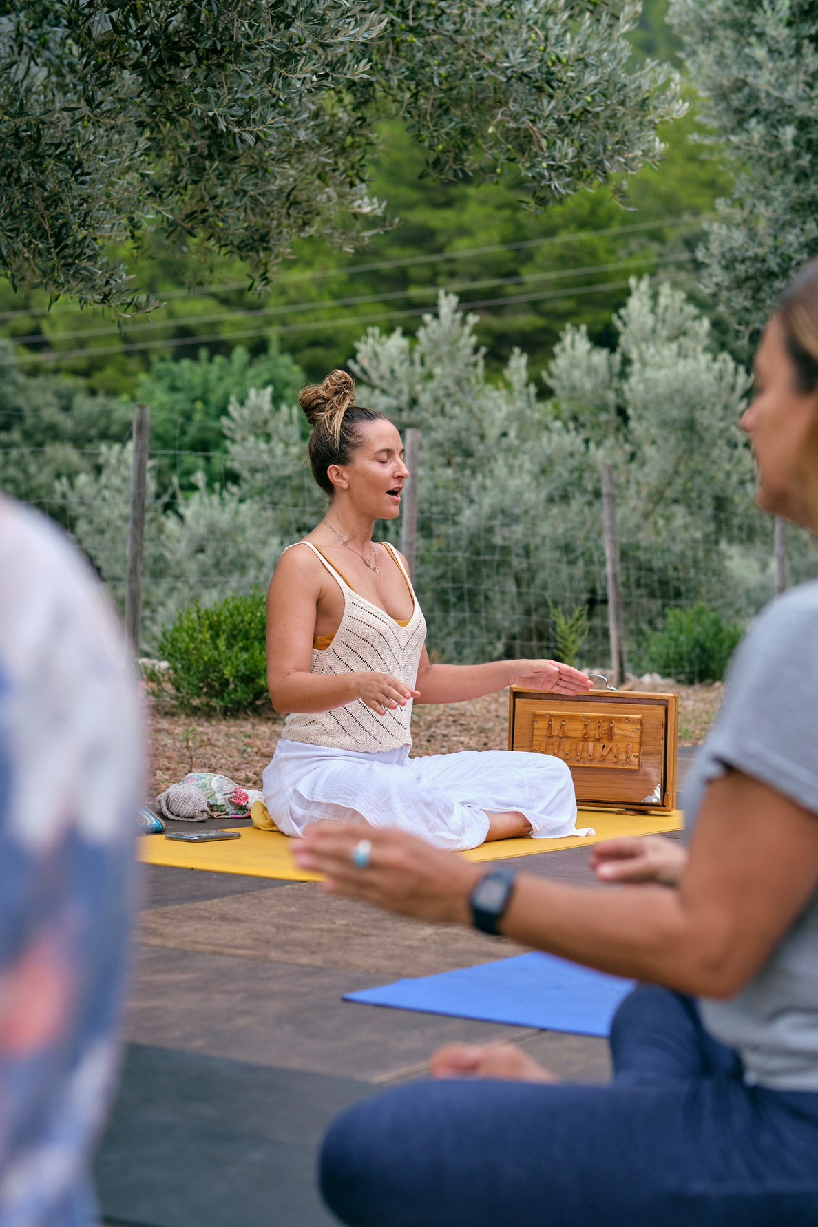 Woman with opened mouth practicing yoga with people